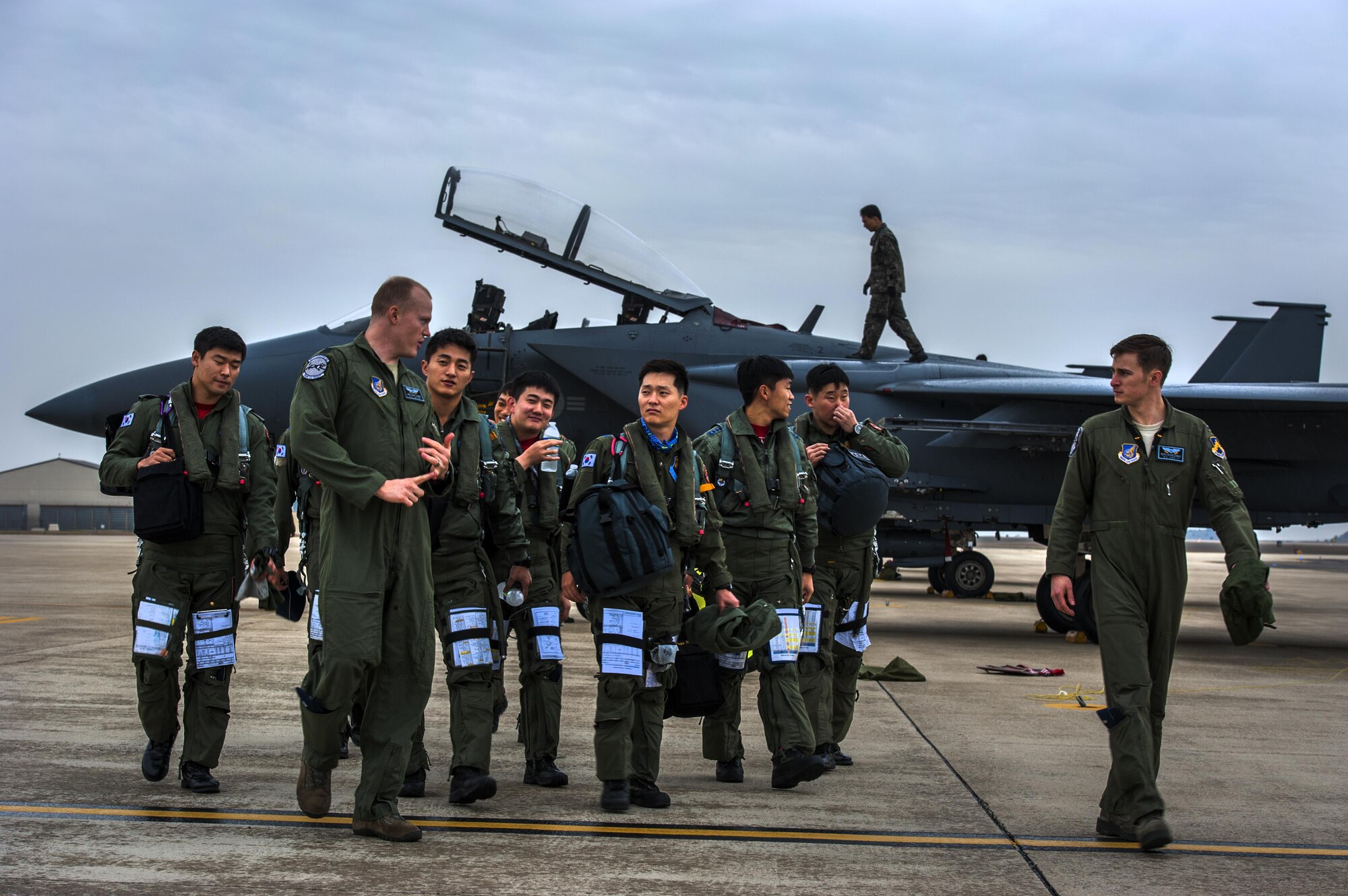 Republic of Korea air force pilots from the 11th Fighter Wing, Daegu Air Base, exchange greetings with pilots from the 35th Fighter Squadron during Buddy Wing 15-7 at Kunsan Air Base, ROK, Nov. 16, 2015. The 11th FW deployed four F-15K Slam Eagles to fly alongside the 8th FW’s F-16 Fighting Falcons during the five-day exercise.  (U.S. Air Force photo by Staff Sgt. Nick Wilson/Released)     