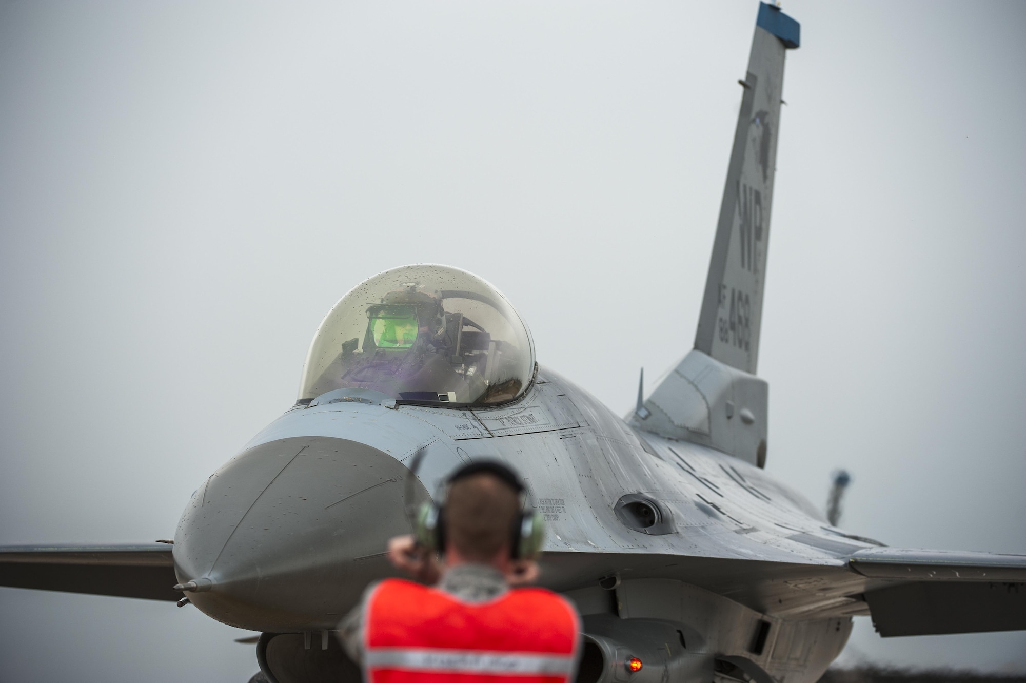 Tech. Sgt. Timothy Whitaker, 8th Aircraft Maintenance Squadron end-of-runway NCO in charge, marshals an F-16 Fighting Falcon during Buddy Wing 15-7 at Kunsan Air Base, Republic of Korea, Nov. 17, 2015. In an effort to enhance U.S. and ROKAF combat capability, Buddy Wing training events are conducted multiple times throughout the year on the peninsula to sharpen interoperability between the allied forces so that if need be, they are always ready to fight as a combined force. (U.S. Air Force photo by Staff Sgt. Nick Wilson/Released)