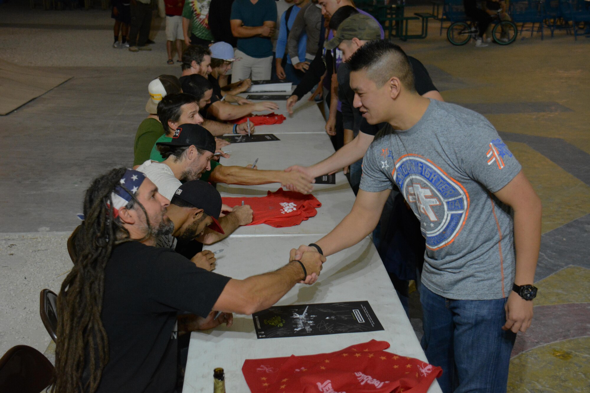 Deployed service members at Al Udeid Air Base, Qatar meet with members of Bikes Over Baghdad after the group performed at the base Nov. 22. The group thanked every service member who attended the show for their service. Bikes Over Baghdad is a professional BMX bike group that tours the world performing for service members. (U.S. Air Force photo by Tech. Sgt. James Hodgman/Released)