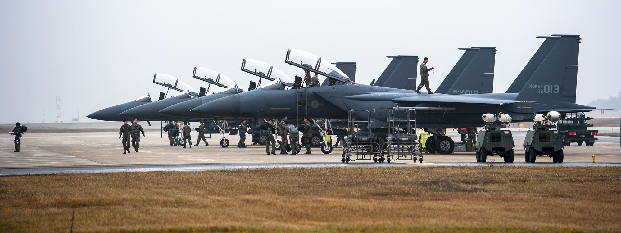 Maintainers from the Republic of Korea air force perform post-flight maintenance on F-15K Slam Eagles from the 11th Fighter Wing, Daegu, during Buddy Wing 15-7 at Kunsan Air Base, Republic of Korea, Nov. 17, 2015. Buddy Wing is part of a combined fighter exchange program designed to improve interoperability between U.S. Air Force and ROKAF fighter squadrons and are conducted multiple times throughout the year in order to promote cultural awareness and sharpen combined combat capabilities. (U.S. Air Force photo by Staff Sgt. Nick Wilson/Released) 