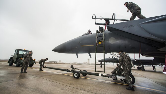 Maintainers from the Republic of Korea air force perform post-flight maintenance on F-15K Slam Eagles from the 11th Fighter Wing, Daegu, during Buddy Wing 15-7 at Kunsan Air Base, Republic of Korea, Nov. 17, 2015. Buddy Wing is part of a combined fighter exchange program designed to improve interoperability between U.S. Air Force and ROKAF fighter squadrons and are conducted multiple times throughout the year in order to promote cultural awareness and sharpen combined combat capabilities. (U.S. Air Force photo by Staff Sgt. Nick Wilson/Released) 