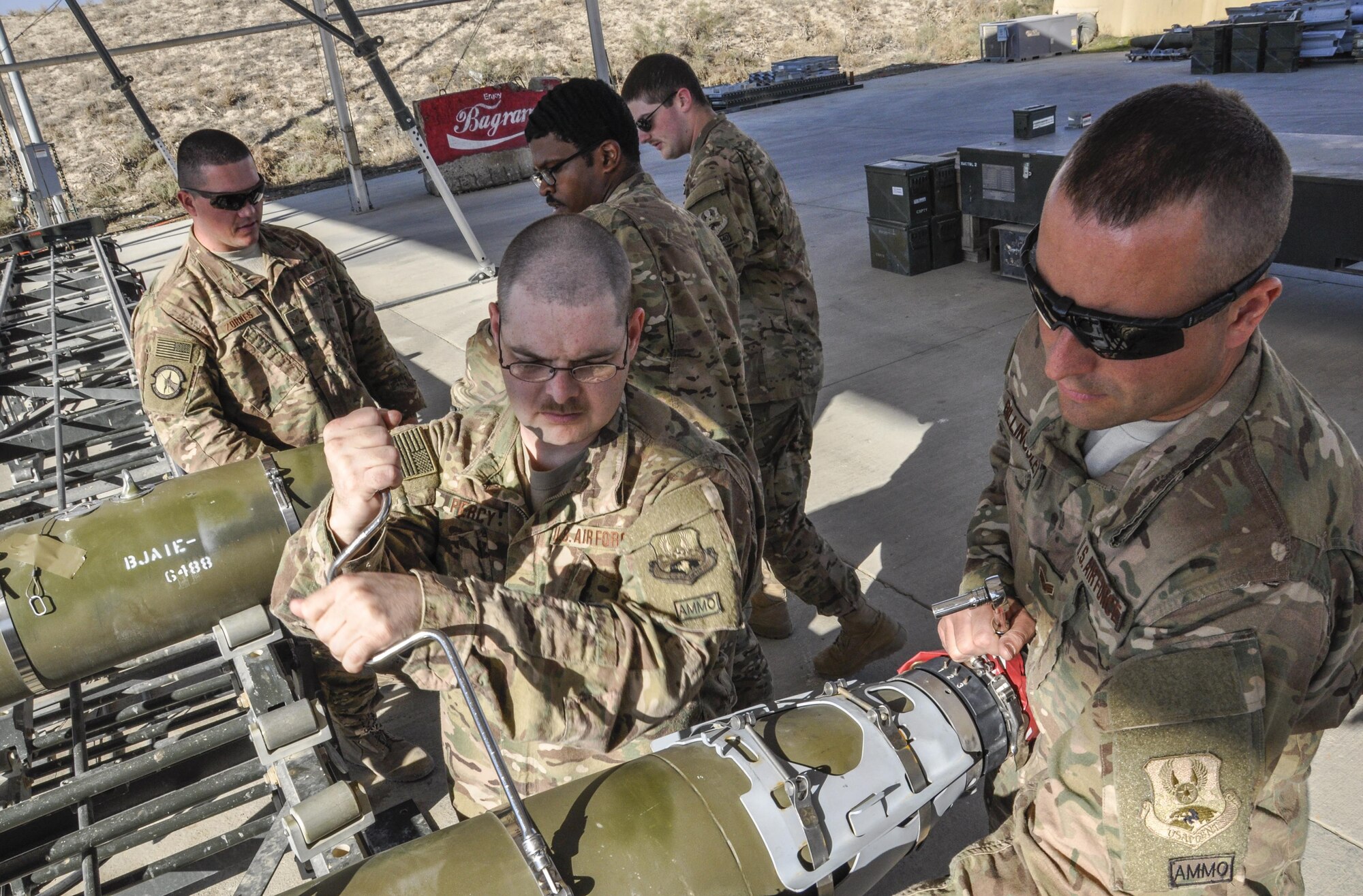 Staff Sgt. Samuel Percy, left, and Staff Sgt. Bryce Billingsly, both from the 455th Expeditionary Maintenance Squadron munitions flight and deployed from Hill Air Force Base, Utah, work on a GBU-54 500 pound bomb at Bagram Airfield, Afghanistan Nov. 17, 2015. The AMMO flight provides necessary weapons and countermeasures required to project combat airpower. (U.S. Air Force photo by Tech. Sgt. Nicholas Rau/Released) 