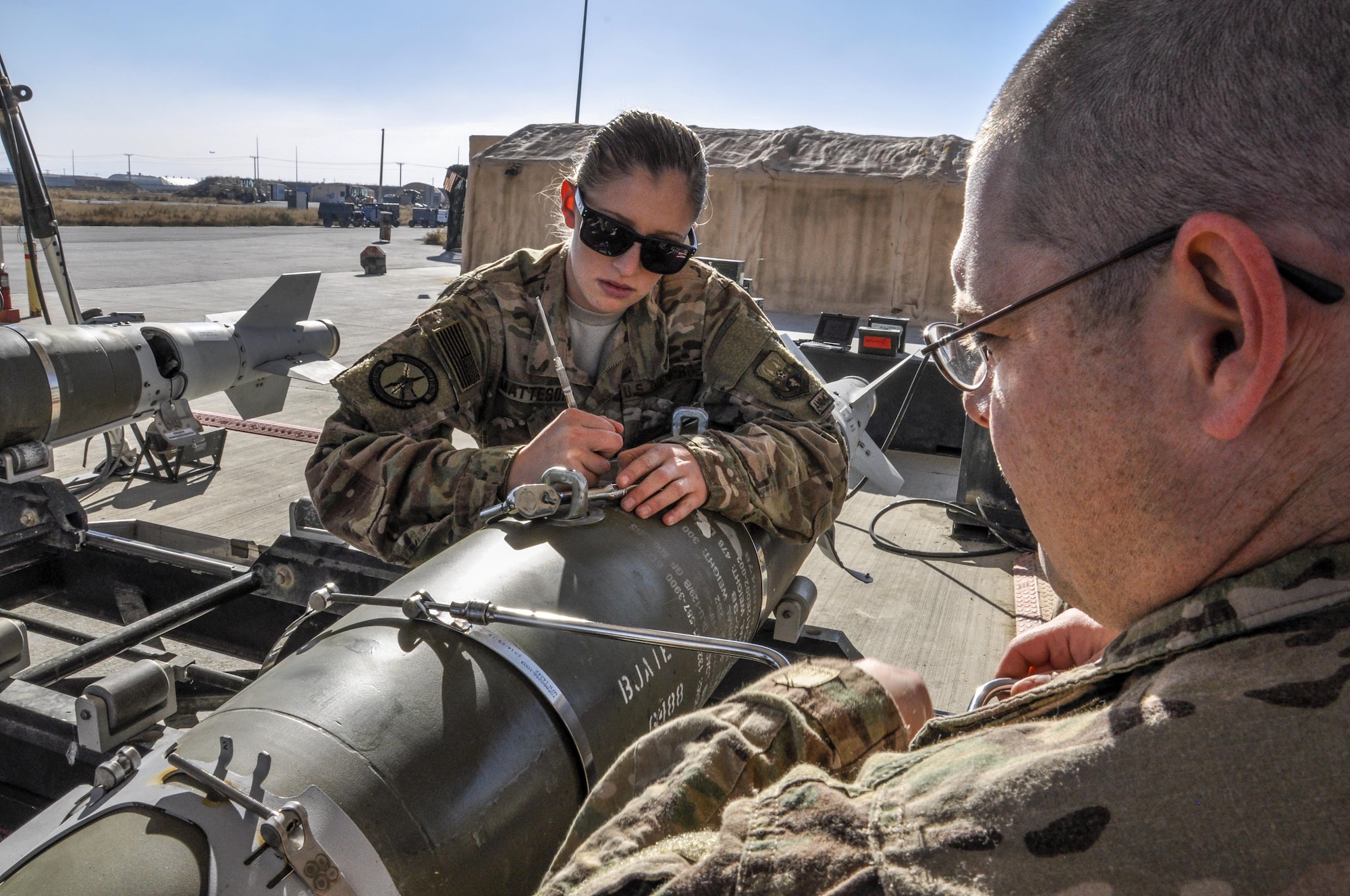 Staff Sgt. Samuel Percy and Airman Morgan Matteson, both from the 455th Expeditionary Maintenance Squadron munitions flight, deployed from Hill Air Force Base, Utah, assemble a GBU-54 500 pound bomb at Bagram Airfield, Afghanistan, Nov. 17, 2015. The AMMO flight provides necessary weapons and countermeasures required to project combat airpower. (U.S. Air Force photo by Tech. Sgt. Nicholas Rau/Released)
