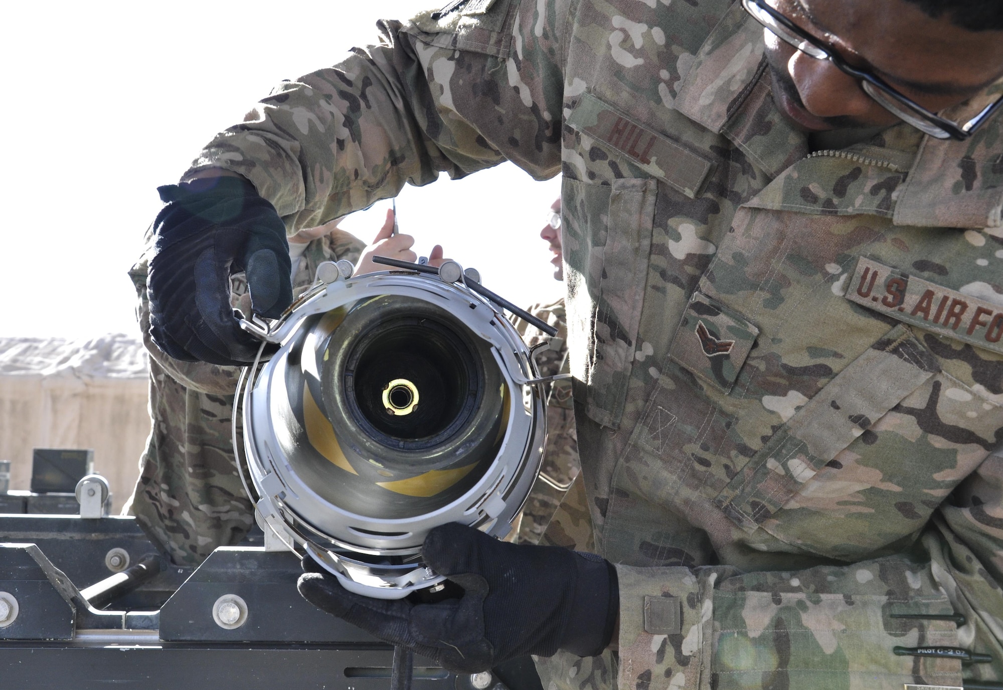 Airman 1st Class Deshawn Hill, 455th Expeditionary Maintenance Squadron munitions flight journeyman, deployed from Hill Air Force Base, Utah, installs a part while building GBU-54 500 pound bomb at Bagram Airfield, Afghanistan, Nov. 17, 2015. The AMMO flight provides necessary weapons and countermeasures required to project combat airpower. (U.S. Air Force photo by Tech. Sgt. Nicholas Rau/Released)