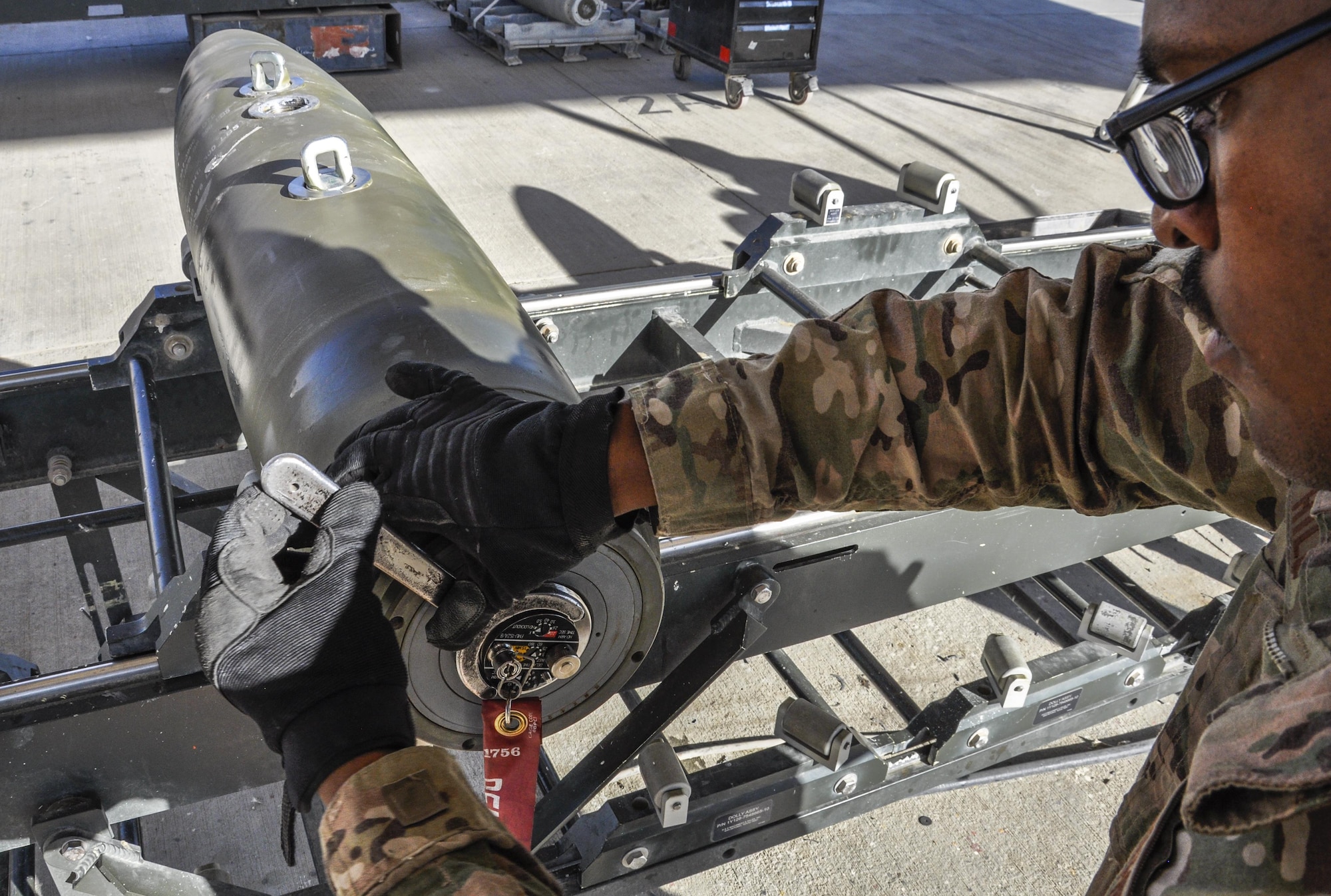 Airman 1st Class Deshawn Hill, 455th Expeditionary Maintenance Squadron munitions flight journeyman, deployed from Hill Air Force Base, Utah, tightens a fuze while building GBU-54 500 pound bomb at Bagram Airfield, Afghanistan, Nov. 17, 2015. The AMMO flight provides necessary weapons and countermeasures required to project combat airpower. (U.S. Air Force photo by Tech. Sgt. Nicholas Rau/Released)