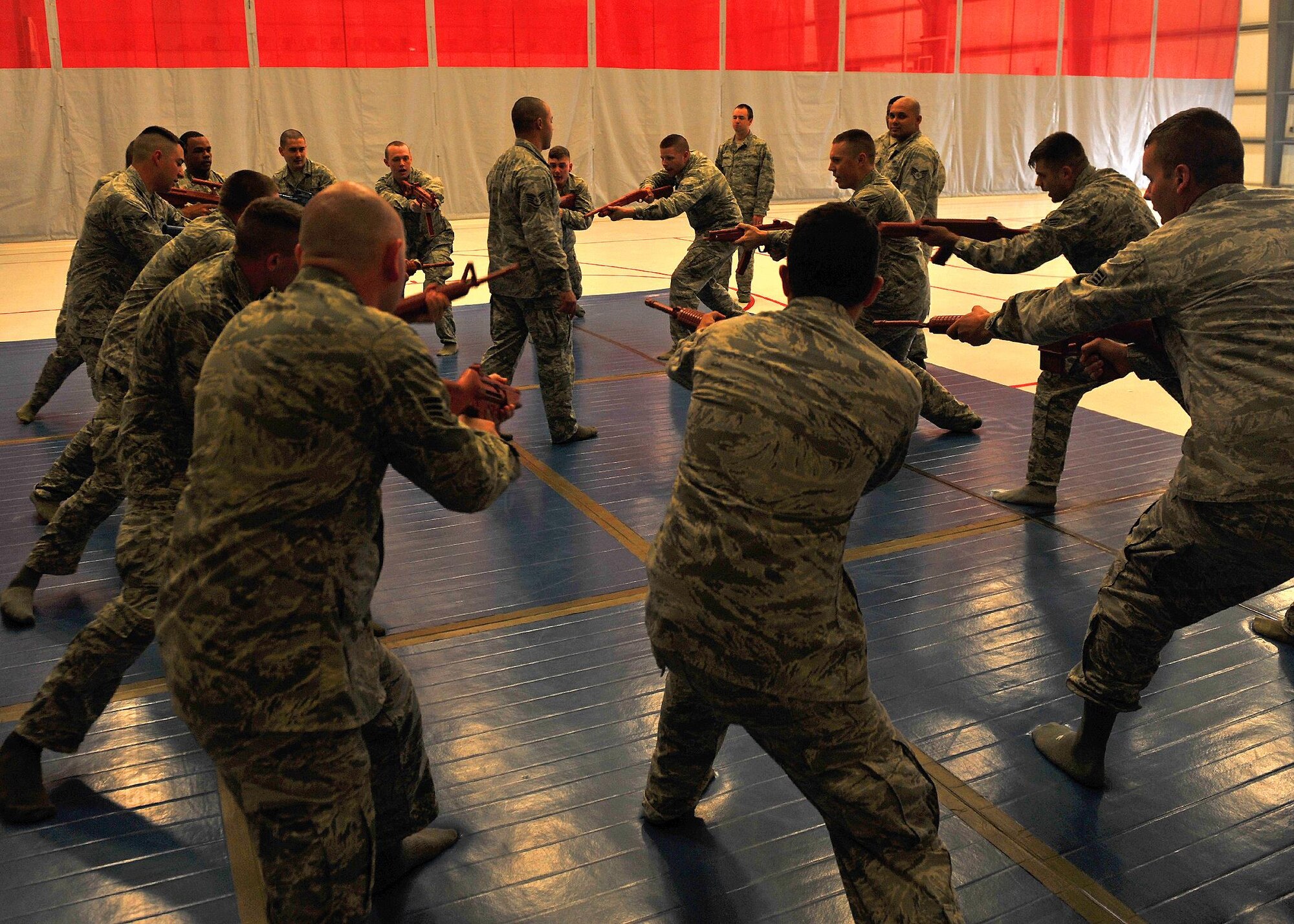 Combatives instructor from the 380th Expeditionary Security Forces Squadron train personnel on weapons control with firearms here, Oct. 15, 2015.  Techniques included learning basic unarmed strikes, weapon control and various body positions from the standing, kneeling and prone.  (U.S. Air Force photo/Staff Sgt. Kentavist Brackin)