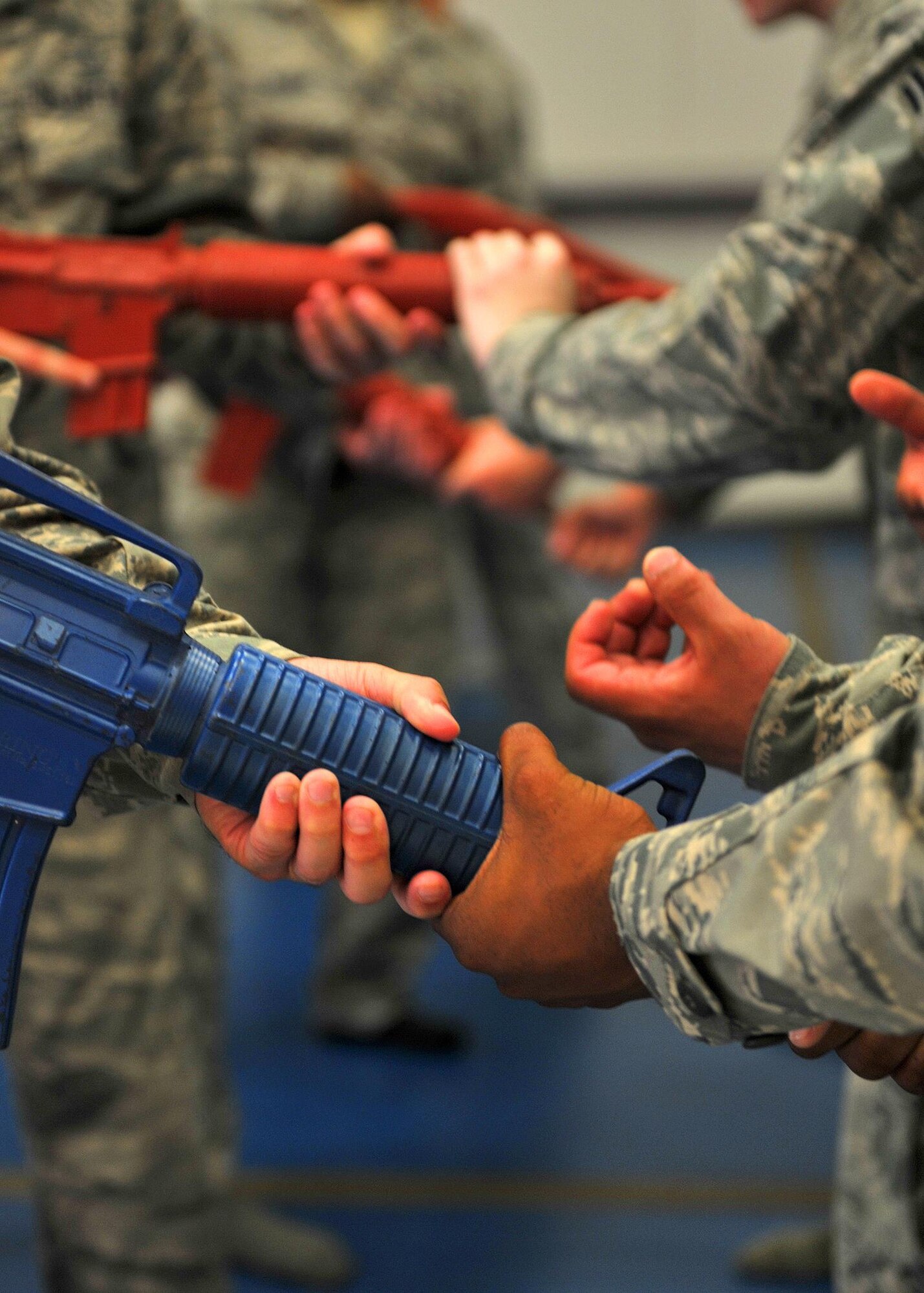 Force protection escorts   learn techniques to remove an opponent’s grip on their weapon during the weapons control portion of combative training here, Oct. 15, 2015.  Techniques included learning basic unarmed strikes, weapon control and various body positions from the standing, kneeling and prone.  (U.S. Air Force photo/Staff Sgt. Kentavist Brackin)