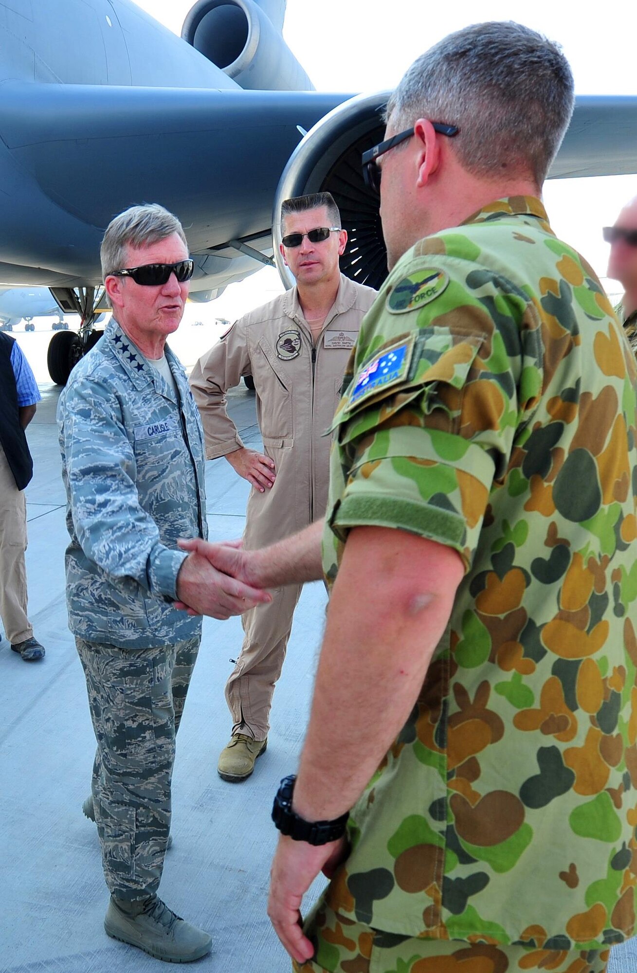 Gen. Hawk Carlisle, commander of Air Combatant Command, shakes hands with Royal Australian Air Force airmen at an undisclosed location in Southwest Asia, Oct. 19, 2015. Carlisle toured several locations around the base including the Air Warfare Center, air control facilities and various flying squadrons on the flight line during his visit. (U.S. Air Force photo by Staff Sgt. Kentavist Brackin/Released)