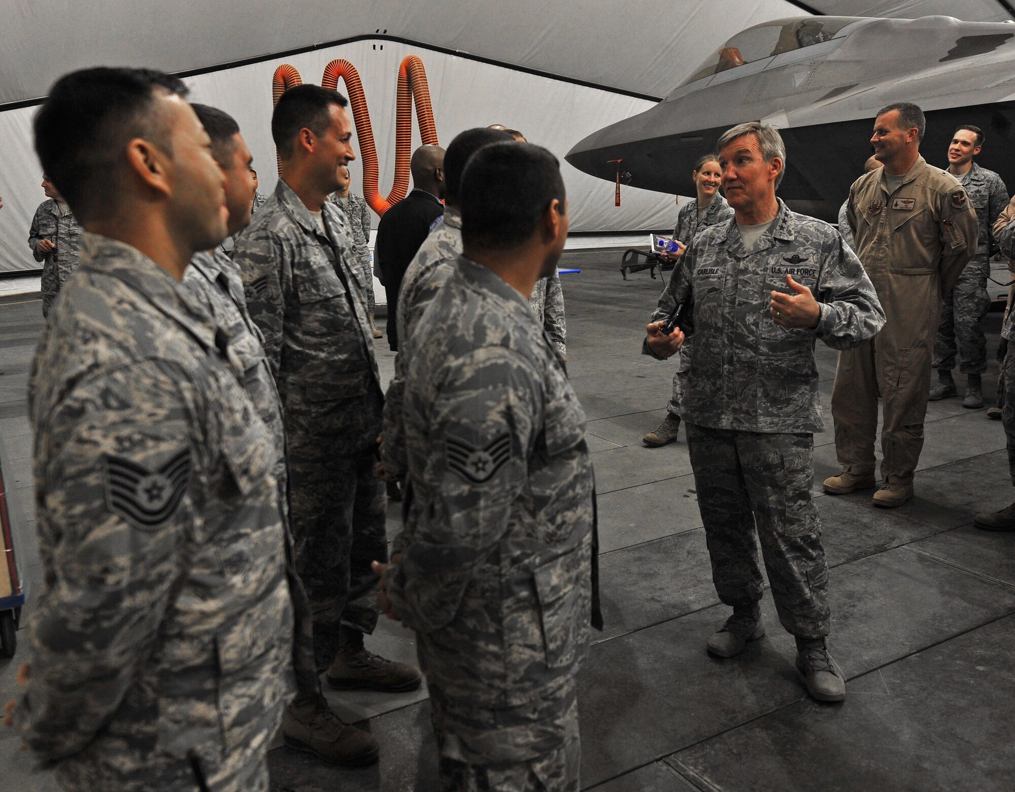 Gen. Hawk Carlisle, commander of Air Combatant Command, speaks with maintainers for the F-22A Raptor in a hangar at an undisclosed location in Southwest Asia, Oct. 19, 2015. Carlisle toured several locations around the base including the Air Warfare Center, air control facility and various flying squadrons during his visit. (U.S. Air Force photo by Staff Sgt. Kentavist Brackin/Released)