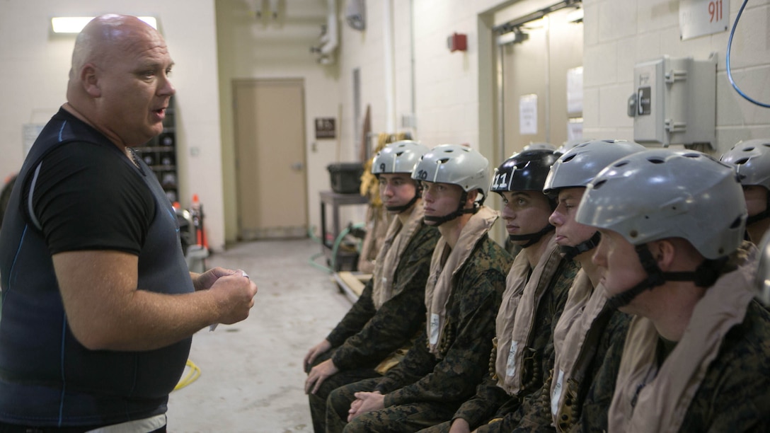 Glenn LaMarque, an underwater trainer instructor, briefs Marines with 2nd Low Altitude Air Defense Battalion on the safety regulations and precautions prior to conducting modular amphibious egress training at the Water Survival Training Facility at Marine Corps Base Camp Lejeune, N.C., Nov. 18, 2015. The Marines participated in the training, which is designed to be a lifesaving course that provides service members with skills and the confidence to successfully and safely exit a helicopter that is submersed in a body of water. 