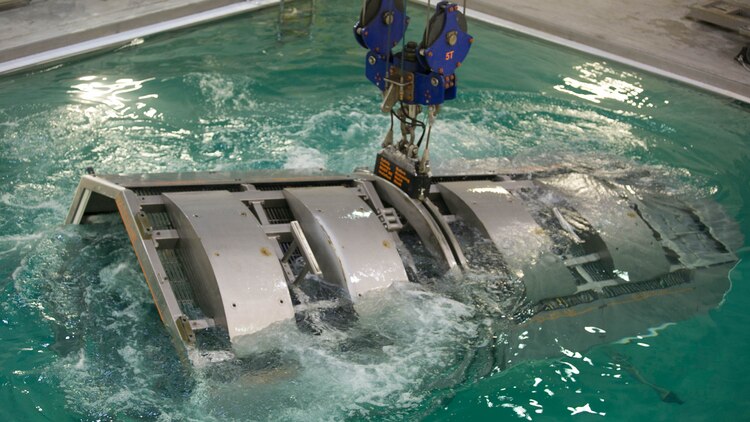 Marines with 2nd Low Altitude Air Defense Battalion and instructors with the Water Survival Training Facility are fully submerged in a pool while aboard a modular amphibious egress mock helicopter during training at Marine Corps Base Camp Lejeune, N.C., Nov. 18, 2015. The Marines participated in the training, which is designed to be a lifesaving course that provides service members with skills and the confidence to successfully and safely exit a helicopter that is submerged in a body of water. 