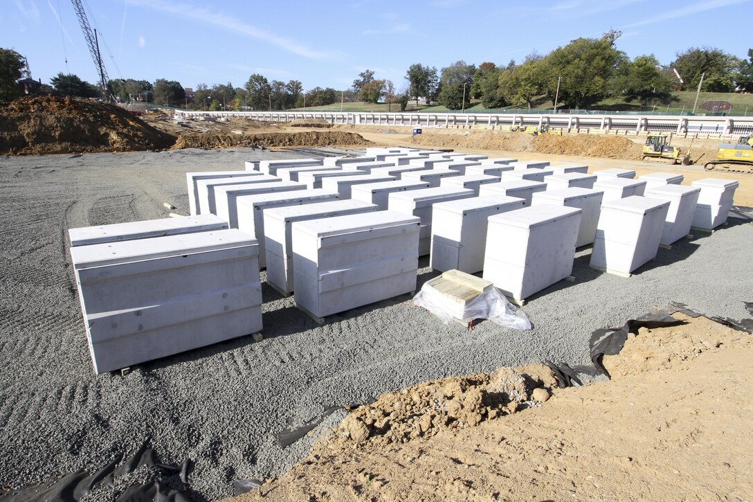 ARLINGTON, Va. -- Double-depth concrete liners are prepositioned on site at Arlington National Cemetery’s Millennium Project here October 20, 2015. The liners are a first for the cemetery, which in the past placed single-depth concrete liners into burial spaces just prior to a funeral service. The new system presets the liners at 18 inches below the surface, allows for two caskets to be placed inside and increases efficiency when prepping a plot for burial. Learn more about the Millennium Project at http://bit.ly/MillenniumProj. (U.S. Army photo/Patrick Bloodgood)  