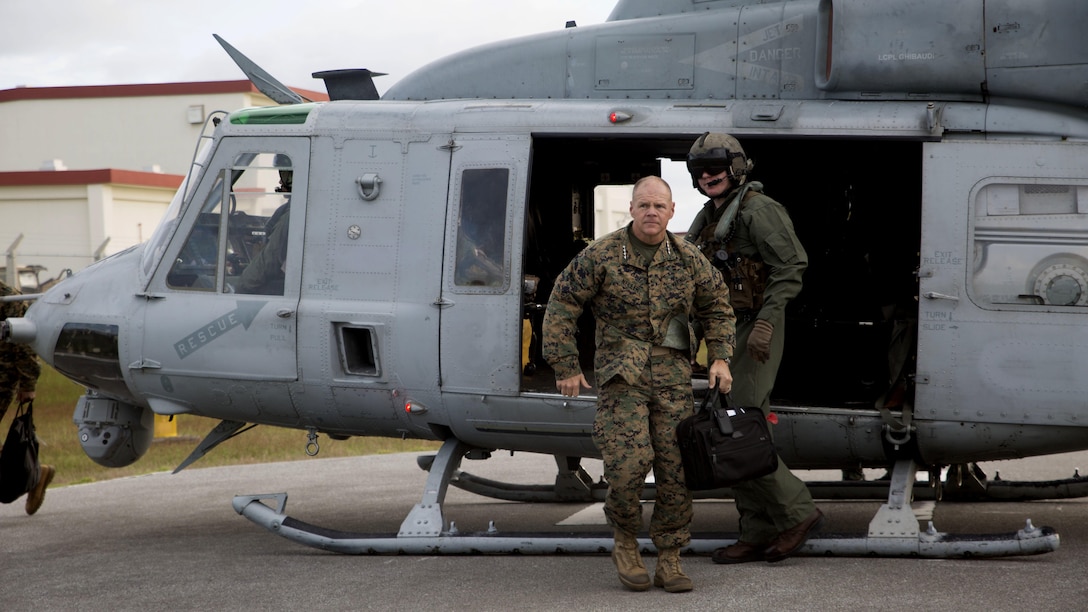 The 37th Commandant of the Marine Corps, Gen. Robert B. Neller steps out of a UH-1 Huey to talk with Marines Nov. 23 at the Camp Hansen Theater, Camp Hansen, Okinawa. Neller, and the Sgt. Maj. of the Marine Corps Ronald L. Green visited service members with III Marine Expeditionary Force, the “tip of the spear,” in the Asia-Pacific region by traveling around and speaking with forward deployed Marines across the installations that comprise Marine Corps Base Camp Smedley D. Butler, Okinawa, Japan. The Marine Corps must be maintained as a crisis response force and a force in readiness, to include the ability for Marines to remain forward deployed and ready to fight and win.