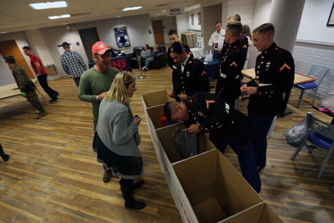 Marines collect toys from concert patrons for Toys for Tots during the 7th annual WRNS Guitar Pull at Marine Corps Air Station Cherry Point, N.C., Nov. 19, 2015. Approximately 2,000 Marines, Sailors and community members gathered for the free concert which was hosted by Marine Corps Community Services and local country music radio station WRNS. The guitar pull featured talents including William Michael Morgan, Cam, Canaan Smith, Cassadee Pope and Waterloo Revival.  (U.S. Marine Corps Photo By Cpl. N.W. Huertas/Released)