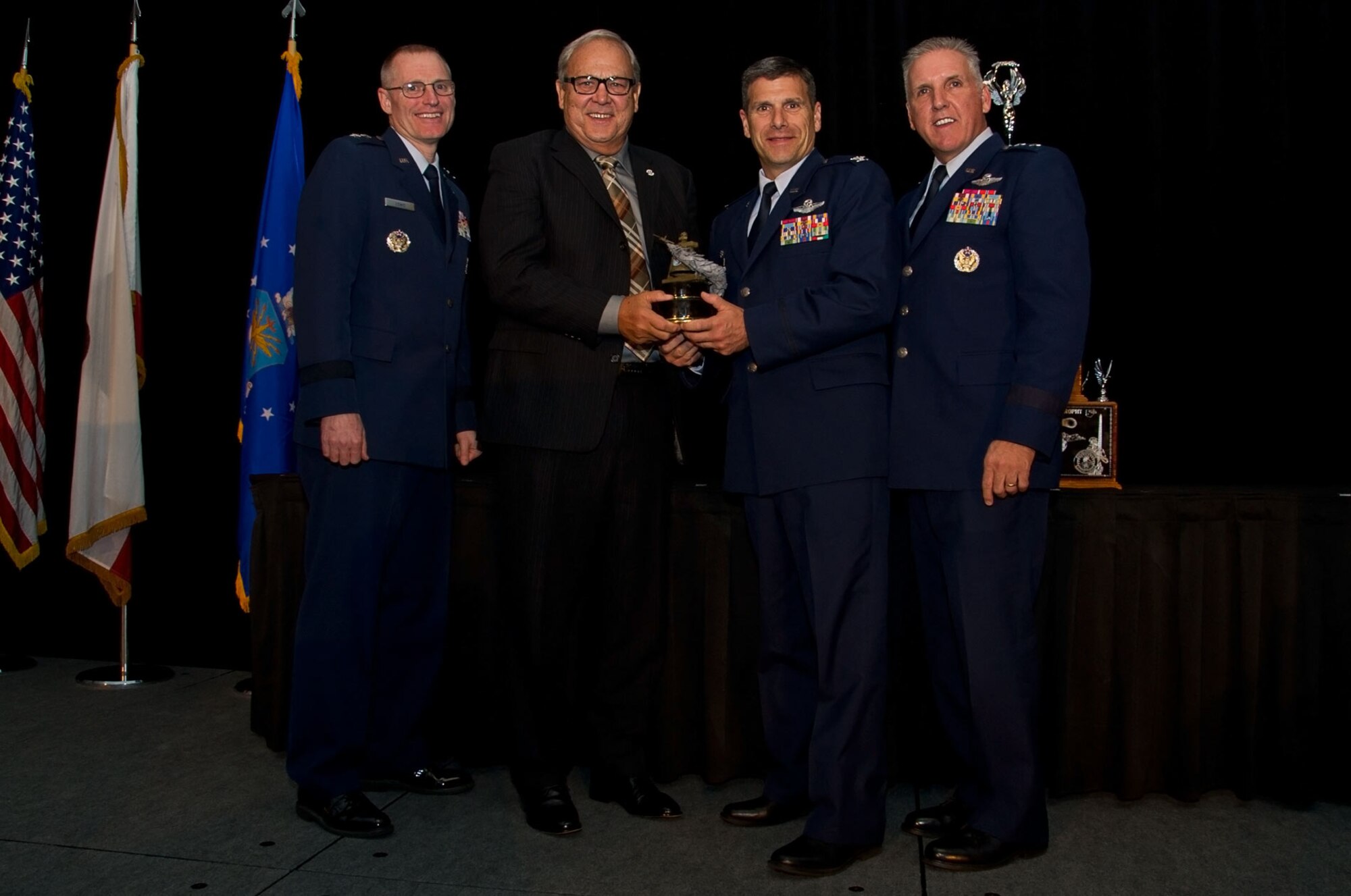 (L-R) Maj. Gen. Kenneth D. Lewis, Jr., director, Air, Space and Information Operations, Air Force Reserve Command, Robins Air Force Base, Georgia; Roger Rupp, Boeing Company and chair, Greater Riverside Chambers of Commerce Military Affairs Committee, Riverside, California; Col. Albert Lupenski, commander, 439th Airlift Wing, Westover Air Reserve Base, Massachusetts; and Maj. Gen. John C. Flournoy, Jr., commander Fourth Air Force, gather at the 16th Annual Raincross Trophy Dinner Nov. 19, 2015, to present the Raincross Trophy, signifying the best wing in the numbered Air Force, to the 439 AW. (U.S. Air Force photo/Senior Master Sgt. Keith Baxter)
