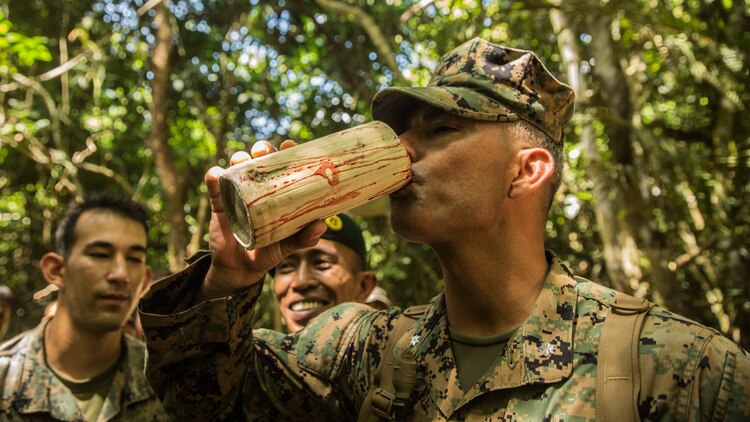 U.S. Marine Lt. Col. Alfred Rivera drinks python blood during a jungle survival course during Malaysia-United States Amphibious Exercise 2015 in Tanduo, Malaysia on Nov. 11. Rivera is the commanding officer of Combat Logistics Battalion 15, 15th Marine Expeditionary Unit. During the course, Marines learned how to trap, clean, and cook wildlife from Malaysian soldiers. The purpose of the exercise was to strengthen military cooperation in the planning and execution of amphibious operations between Malaysian armed forces and U.S. Marines. The 15th MEU is currently deployed in the Indo-Asia-Pacific region to promote regional stability and security in the U.S. 7th Fleet area of operations. (U.S. Marine Corps photo by Sgt. Emmanuel Ramos/Released)