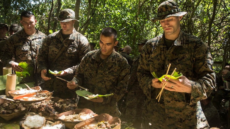 U.S. Marines with Kilo Company, Battalion Landing Team 3rd Battalion, 1st Marine Regiment, 15th Marine Expeditionary Unit, enjoy a meal prepared by Malaysian soldiers in a jungle survival course during Malaysia-United States Amphibious Exercise 2015 in Tanduo, Malaysia on Nov. 11. The meal included lizard, turtle, python, fish, bats, birds, rice cooked in coconuts, and a salad made of jungle vegetation. The purpose of the exercise was to strengthen military cooperation in the planning and execution of amphibious operations between Malaysian armed forces and U.S. Marines. The 15th MEU is currently deployed in the Indo-Asia-Pacific region to promote regional stability and security in the U.S. 7th Fleet area of operations. 