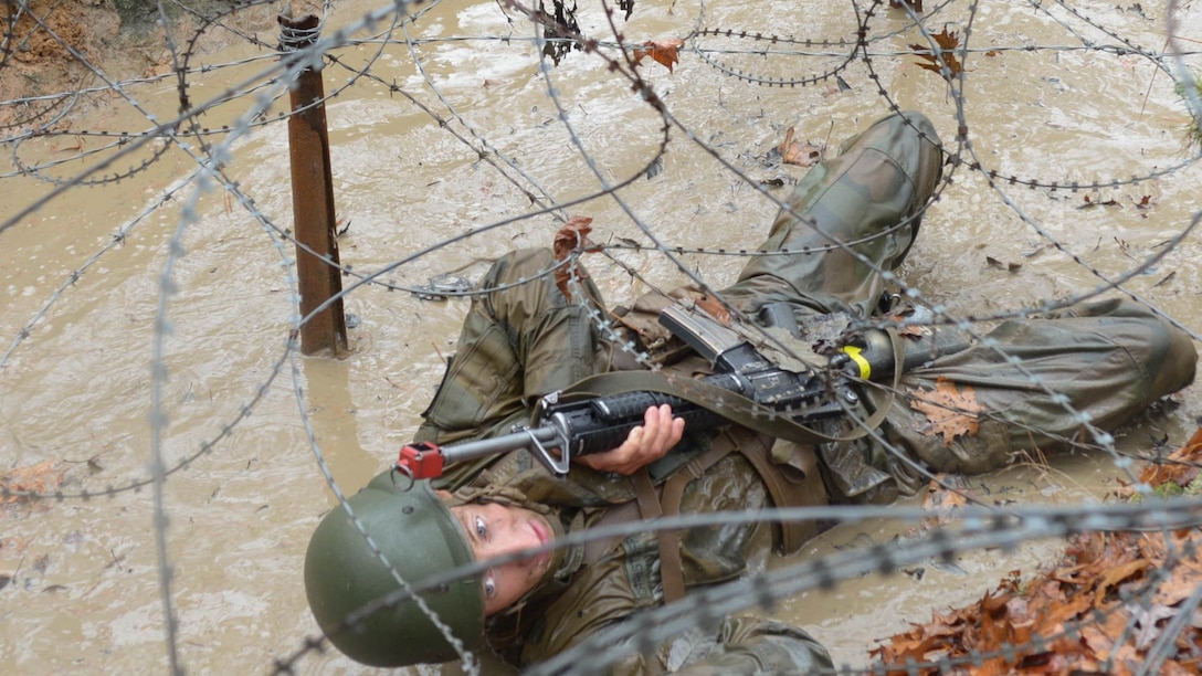 A Norwegian cadet pulls himself under barbed wire while completing the Combat Course at Officer Candidate School.While most candidates arrive at OCS via a combination of air and personal vehicle travel, the Norwegian cadets sailed a 101-year-old, three-masted steel bark known as the “Statsraad Lehmkuhl” from Norway to Baltimore. 