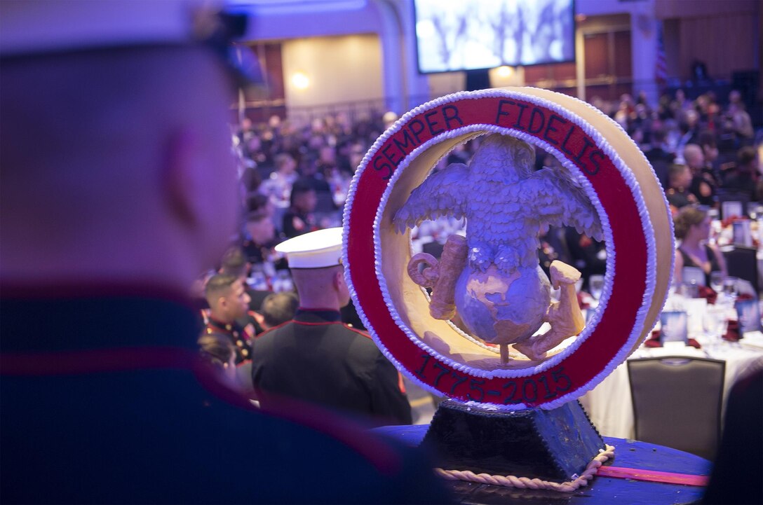 A Marine from Marine Barracks Washington D.C. stands behind the birthday cake during the 240th Marine Corps Birthday celebration Nov. 21, 2015, in Washington, D.C. Gen. Joseph Dunford Jr., chairman Joint Chiefs of Staff, was the guest of honor during the ceremony.  (Department of Defense photo by Petty Officer 2nd Class Dominique A. Pineiro)