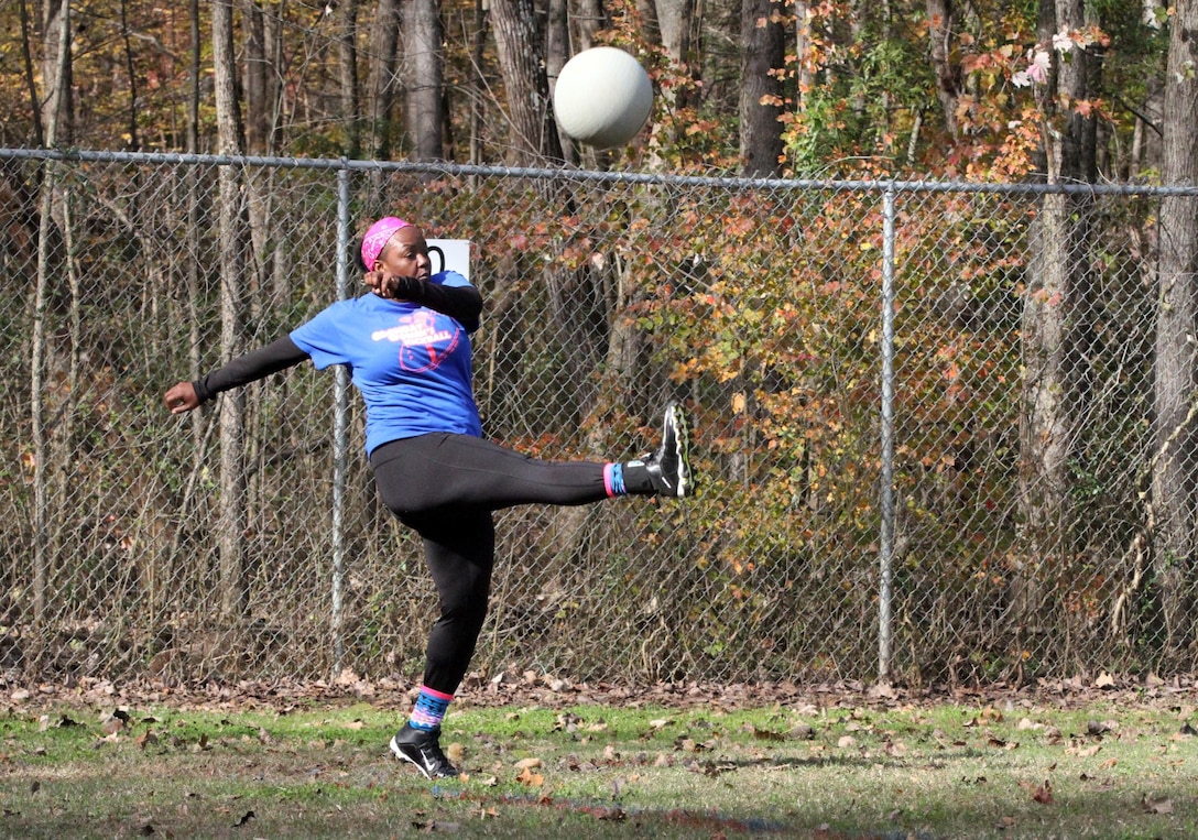 Staff Sgt. Gretta Smith, an executive administrative assistant with the 108th Training Command (Initial Entry Training) kicks the ball during a practice kickball game Nov. 15, 2015, at Clanton Park in Charlotte, N.C. Smith plays with an all-female kickball team which is part of the “Ladies under the Lights” kickball league as a way of interacting with her community. (U.S. Army photo by Sgt. Javier Amador)