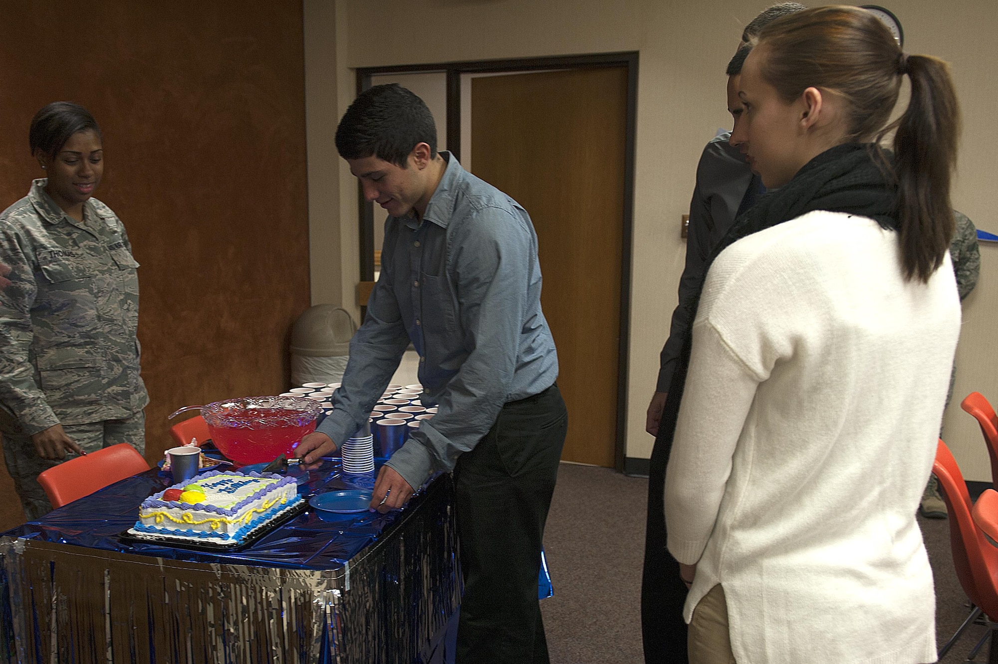 Angelo State University U.S. Air Force ROTC Detachment 847 cadets gather around a birthday cake for those who had birthdays during the Air Force ROTC Ceremony at Angelo State University, San Angelo, Texas, Nov. 18, 2015. The cadets are trained through Air Force ROTC Detachment 847 to commission into the Air Force. (U.S. Air Force photo by Airman 1st Class Caelynn Ferguson/Released)