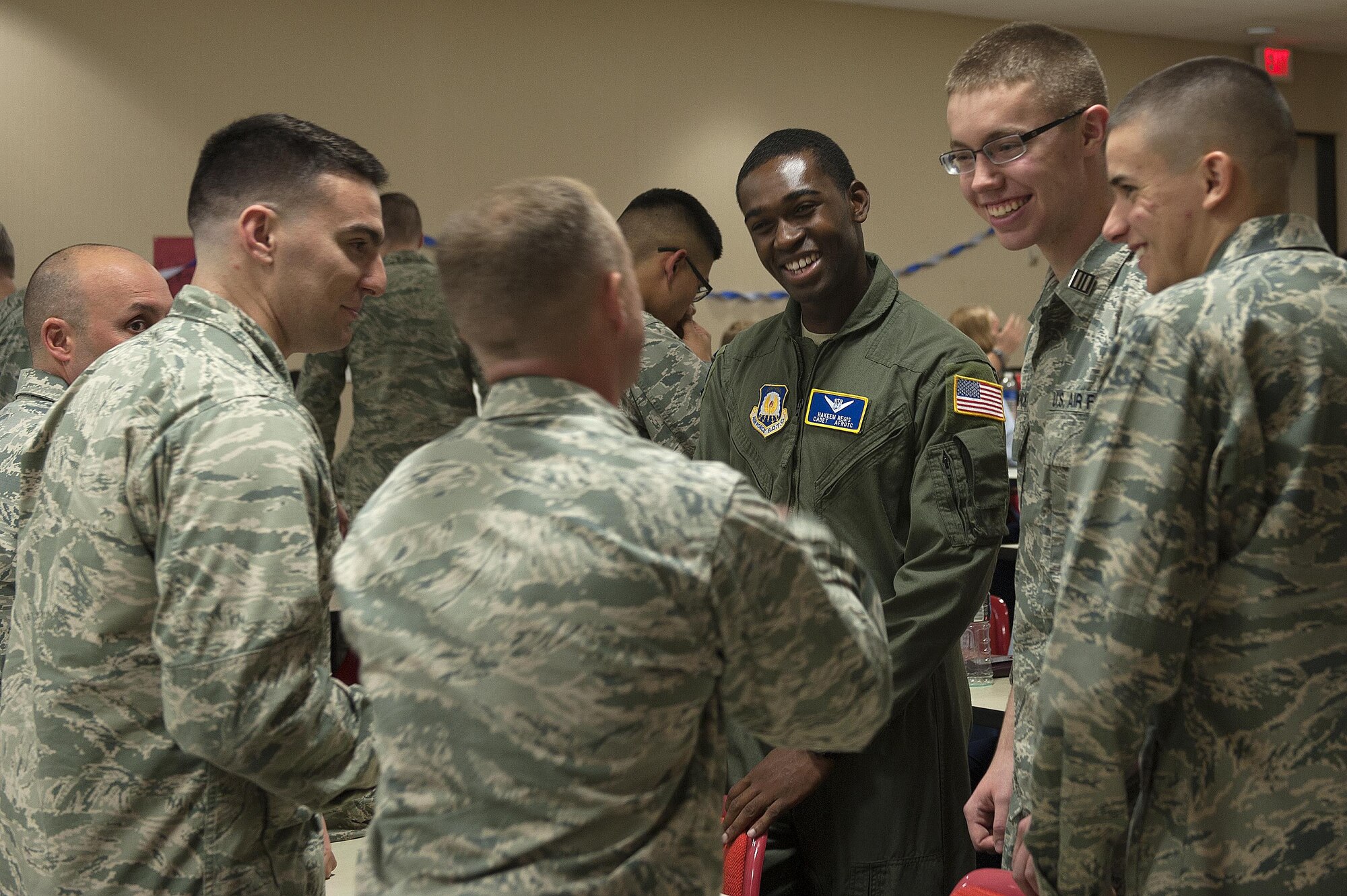 Angelo State University U.S. Air Force ROTC Detachment 847 cadets laugh and converse during an Air Force ROTC Ceremony at Angelo State University, San Angelo, Texas, Nov. 18, 2015. Cadets are given the opportunity to apply for pilot slots through the Department of Aerospace Studies. (U.S. Air Force photo by Airman 1st Class Caelynn Ferguson/Released)