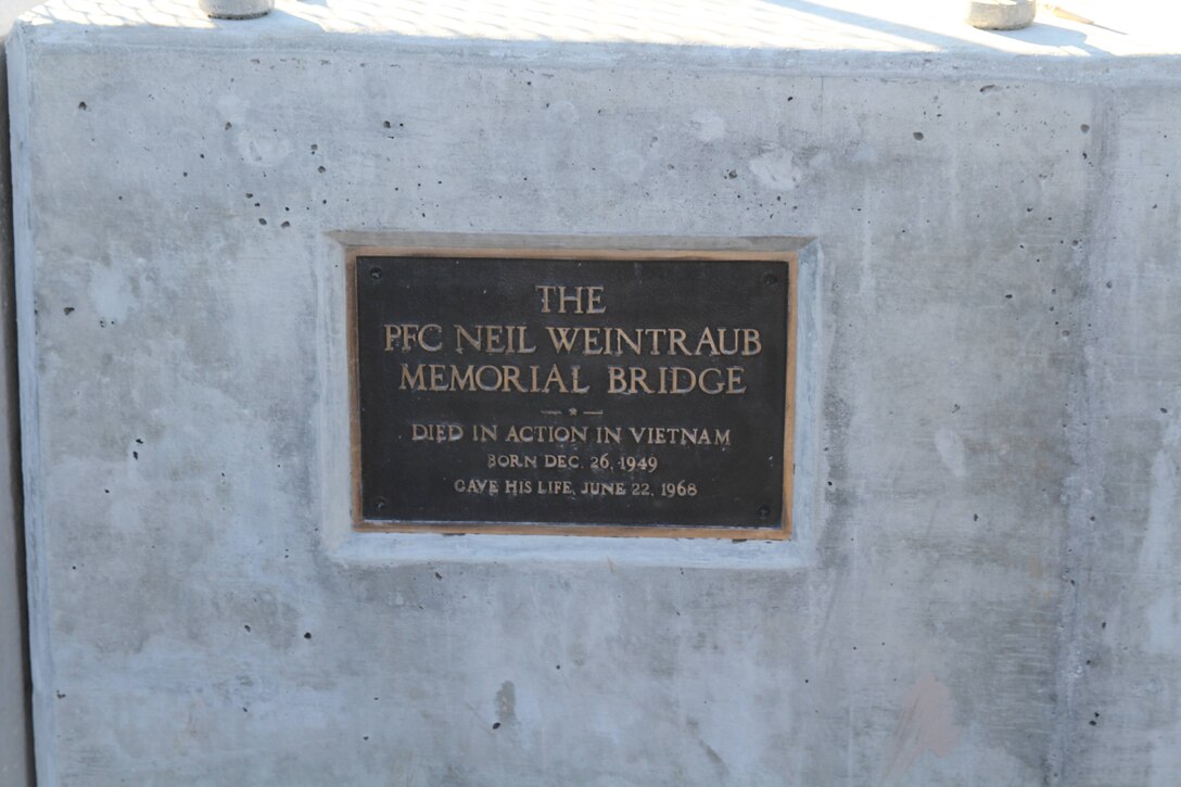 The bronze plaque honoring Private First Class Neil Weintraub rests on the side of ‘The PFC Neil William Weintraub Memorial Bridge where it is mounted. The bridge was re-dedicated to Weintraub on November 14, in Bensalem, Pennsylvania. The ceremony was held to remember PFC Neil William Weintraub, a Marine who was killed in action during the Vietnam War on top of Hill 512 near Khe Sanh. (U.S. Marine Corps Courtesy Photo/Released)