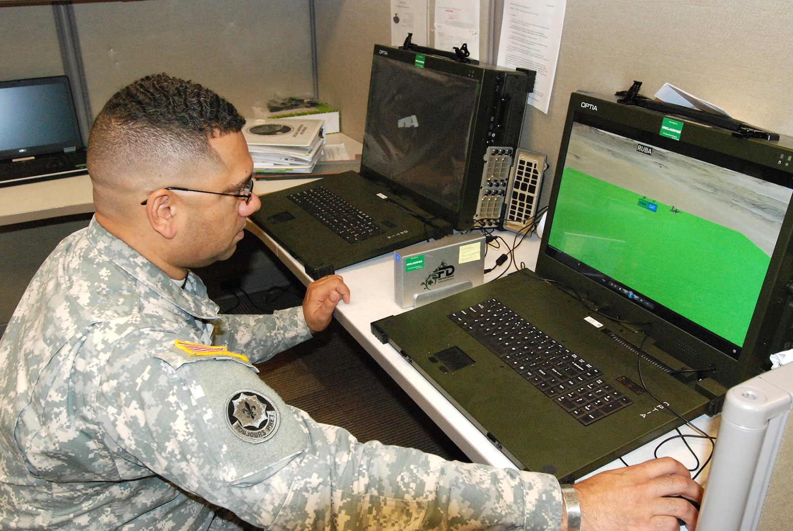 Chief Warrant Officer 4 Jason Feser, 512th Geospatial Engineer Detachment commander, uses the TerraExplorer to show 3-D graphic videos that are used to represent military operations. The program provides commanders with graphic information before operations begin to help make key decisions during the process of humanitarian operations.
