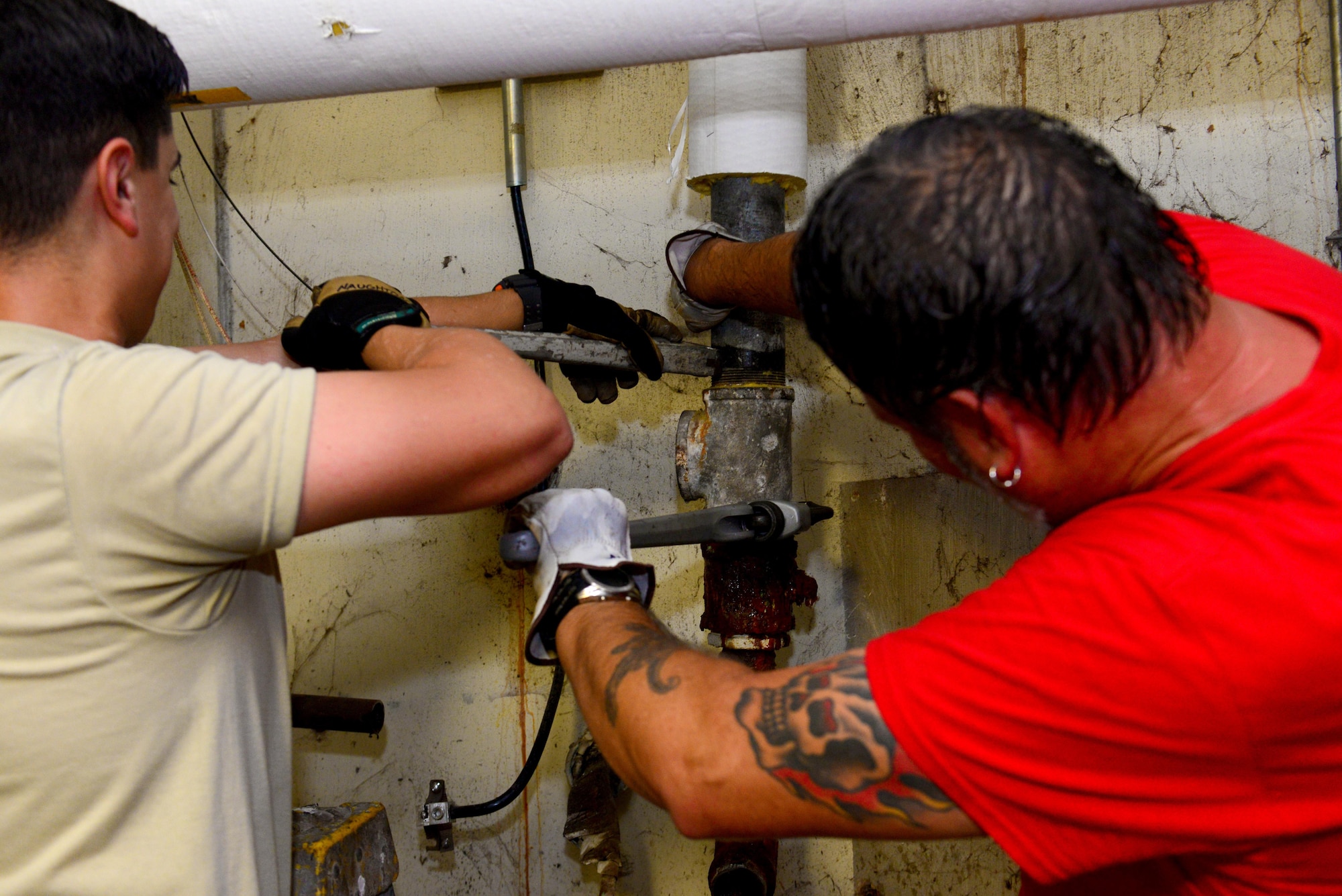 Airman 1st Class Michael Naughton, 2nd Civil Engineer Squadron water and fuel systems apprentice, left, and Glenn Hannis, 2nd CES water and fuel systems plumber, unscrew and replace corroded water piping for the Air Force Global Strike command headquarters at Barksdale Air Force Base, La., Nov. 17, 2015. Water and fuel systems Airmen must be able to problem solve and think on the fly when replacing large or complex water systems. (U.S. Air Force Photo/Airman 1st Class Luke Hill)
