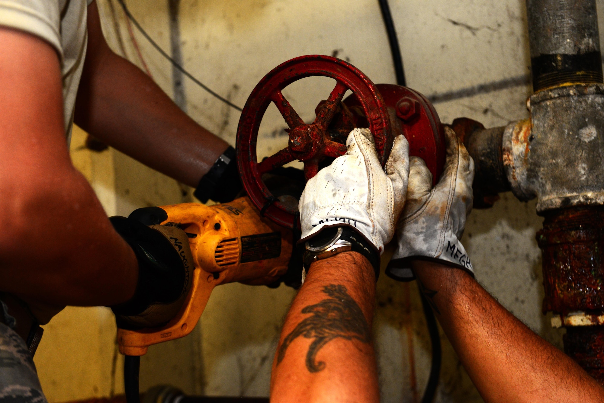 Airman 1st Class Michael Naughton, 2nd Civil Engineer Squadron water and fuel systems apprentice, left, and Glenn Hannis, 2nd CES water and fuel systems plumber, remove old piping from a water service line at Barksdale Air Force Base, La., Nov. 17, 2015. The service line provides water to an entire building including water used by heating, ventilation and air conditioning systems and fire systems. (U.S. Air Force Photo/Airman 1st Class Luke Hill)