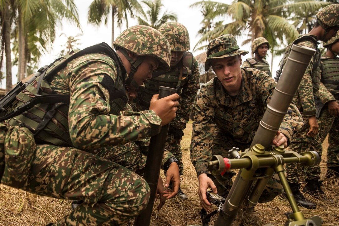 TANDUO BEACH, Malaysia (Nov. 10, 2015) U.S. Marine Lance Cpl. Joey Hocker demonstrates how to operate an M224A1 60 mm mortar system to Malaysian soldiers during Malaysia-United States Amphibious Exercise 2015. Hocker is a team leader with Kilo Company, Battalion Landing Team 3rd Battalion, 1st Marine Regiment, 15th Marine Expeditionary Unit. During MALUS AMPHEX 15, Marines with the 15th MEU and Malaysian soldiers exchanged infantry weapon capabilities and tactics. The purpose of the exercise was to strengthen military cooperation in the planning and execution of amphibious operations between Malaysian armed forces and U.S. Marines. The 15th MEU is currently deployed in the Indo-Asia-Pacific region to promote regional stability and security in the U.S. 7th Fleet area of operations. (U.S. Marine Corps photo by Sgt. Emmanuel Ramos/Released)
