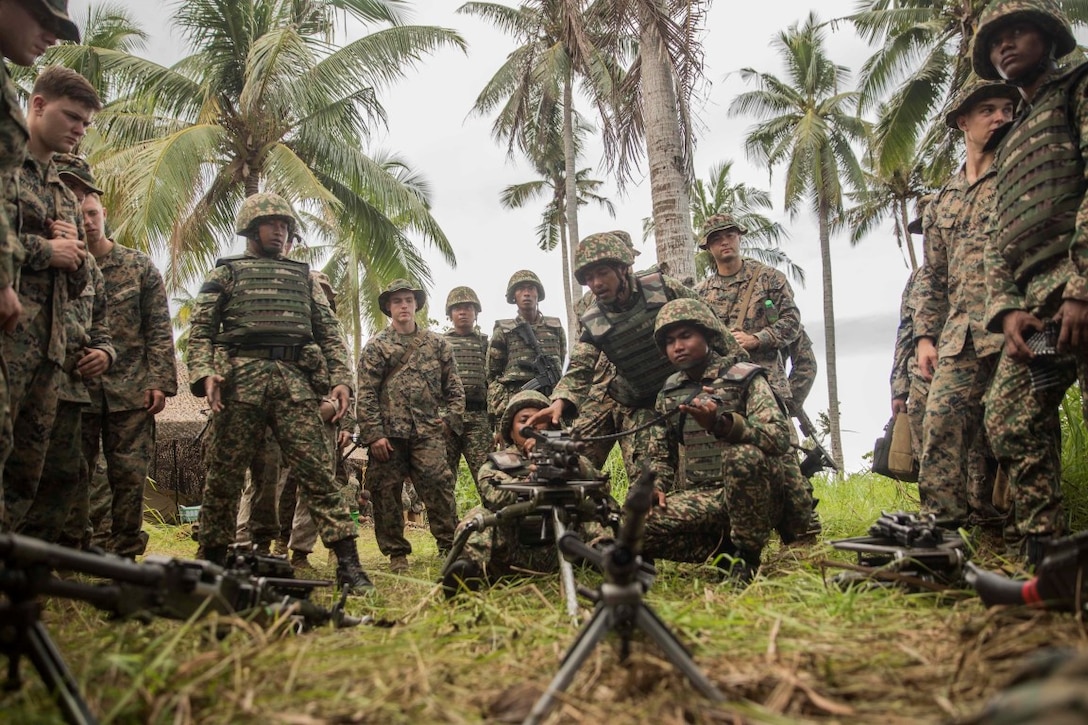 TANDUO BEACH, Malaysia (Nov. 10, 2015) Malaysian soldiers demonstrate to U.S. Marines with Kilo Company, Battalion Landing Team 3rd Battalion, 1st Marine Regiment, 15th Marine Expeditionary Unit, how they operate their machine gun during Malaysia-United States Amphibious Exercise 2015. During MALUS AMPHEX 15, Marines with the 15th MEU and Malaysian soldiers exchanged infantry weapon capabilities and tactics. The purpose of the exercise was to strengthen military cooperation in the planning and execution of amphibious operations between Malaysian armed forces and U.S. Marines. The 15th MEU is currently deployed in the Indo-Asia-Pacific region to promote regional stability and security in the U.S. 7th Fleet area of operations. (U.S. Marine Corps photo by Sgt. Emmanuel Ramos/Released)