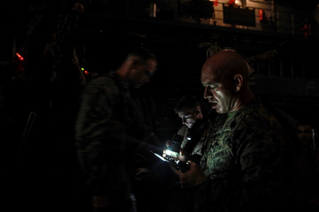 TANDUO, Malaysia (Nov. 10, 2015) U.S. Marine 1st Sgt. David McDonald keeps record of his Marines while they depart for interoperability training with the Malaysian Army during Malaysia-United States Amphibious Exercise 2015. McDonald is the company first sergeant for Kilo Co., Battalion Landing Team, 3rd Battalion, 1st Marine Regiment, 15th Marine Expeditionary Unit. During MALUS AMPHEX 15, Marines with the 15th Marine Expeditionary Unit worked with Malaysian armed forces sharing jungle survival skills, jungle warfare tactics, and amphibious operations. The purpose of the exercise was to strengthen military cooperation in the planning and execution of amphibious operations between Malaysian armed forces and U.S. Marines. The 15th MEU is currently deployed in the Indo-Asia-Pacific region to promote regional stability and security in the U.S. 7th Fleet area of operations. (U.S. Marine Corps photo by Sgt. Emmanuel Ramos/Released)
