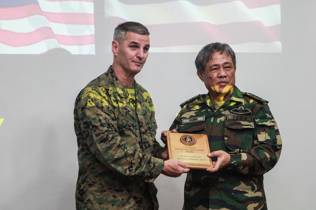 SABAH, Malaysia (Nov. 10, 2015) U.S. Marine Brig. Gen. Christopher J. Mahoney, right, presents Lt. Gen. Dato’Sri Haji Sabri Bin Adam with a plaque during the opening ceremony to commemorate Malaysia-United States Amphibious Exercise 2015. Mahoney is the deputy commander of Marine Forces Pacific. During MALUS AMPHEX 15, Marines with the 15th Marine Expeditionary Unit worked with Malaysian armed forces sharing jungle survival skills, jungle warfare tactics, and amphibious operations. The purpose of the exercise was to strengthen military cooperation in the planning and execution of amphibious operations between Malaysian armed forces and U.S. Marines. The 15th MEU is currently deployed in the Indo-Asia-Pacific region to promote regional stability and security in the U.S. 7th Fleet area of operations. (U.S. Marine Corps photo by Sgt. Emmanuel Ramos/Released)