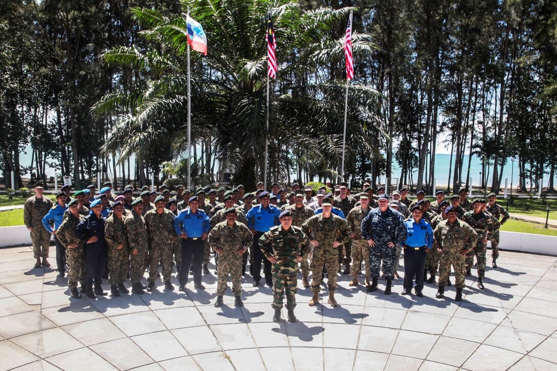 TANDUO, Malaysia (Nov. 10, 2015) U.S. Marines with the 15th Marine Expeditionary Unit pose alongside Malaysian armed forces for a photo during the opening ceremony for Malaysia-United States Amphibious Exercise 2015. During MALUS AMPHEX 15, Marines with the 15th Marine Expeditionary Unit worked with Malaysian armed forces sharing jungle survival skills, jungle warfare tactics, and amphibious operations. The purpose of the exercise was to strengthen military cooperation in the planning and execution of amphibious operations between Malaysian armed forces and U.S. Marines. The 15th MEU is currently deployed in the Indo-Asia-Pacific region to promote regional stability and security in the U.S. 7th Fleet area of operations. (U.S. Marine Corps photo by Sgt. Emmanuel Ramos/Released)