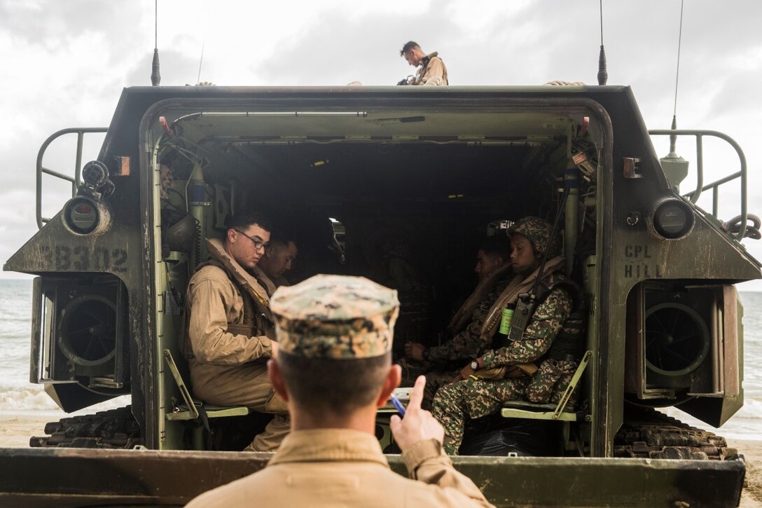 TANDUO BEACH, Malaysia (Nov. 11, 2015) U.S. Marines with Kilo Company, Battalion Landing Team 3rd Battalion, 1st Marine Regiment, 15th Marine Expeditionary Unit, and Malaysian soldiers prepare to rehearse amphibious operations during Malaysia-United States Amphibious Exercise 2015. During MALUS AMPHEX 15, Marine fire teams paired with a squad of Malaysian soldiers and rehearsed amphibious assault tactics. The purpose of the exercise was to strengthen military cooperation in the planning and execution of amphibious operations between Malaysian armed forces and U.S. Marines. The 15th MEU is currently deployed in the Indo-Asia-Pacific region to promote regional stability and security in the U.S. 7th Fleet area of operations. (U.S. Marine Corps photo by Sgt. Emmanuel Ramos/Released)