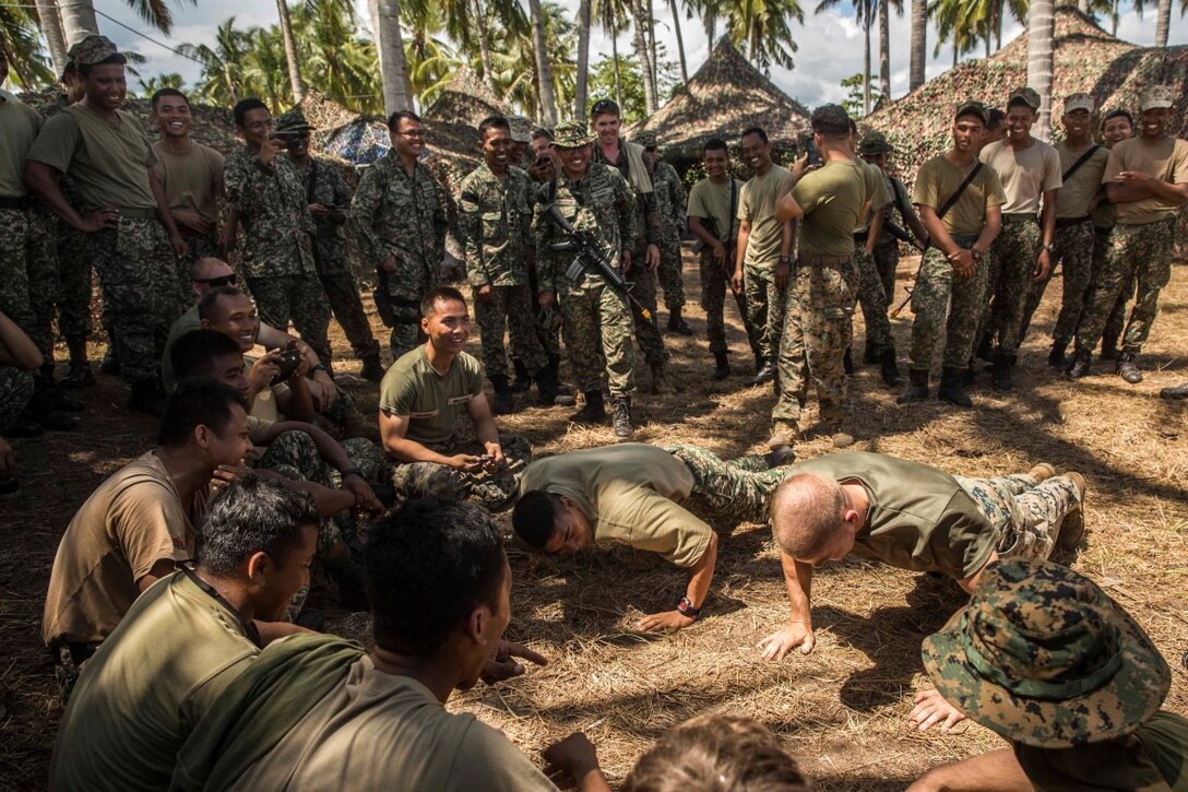 TANDUO BEACH, Malaysia (Nov. 12, 2015) U.S. Marine Cpl. Forrest Walker and a Malaysian soldier compete in a push up competition during Malaysia-United States Amphibious Exercise 2015. Walker is a team leader with Kilo Company, Battalion Landing Team 3rd Battalion, 1st Marine Regiment, 15th Marine Expeditionary Unit.  During the integration, Marines and soldiers learned about each other’s culture, country, military service, exchanged personal gifts, and ended with a barbeque. The purpose of the exercise was to strengthen military cooperation in the planning and execution of amphibious operations between Malaysian armed forces and U.S. Marines. The 15th MEU is currently deployed in the Indo-Asia-Pacific region to promote regional stability and security in the U.S. 7th Fleet area of operations.  (U.S. Marine Corps photo by Sgt. Emmanuel Ramos/Released)