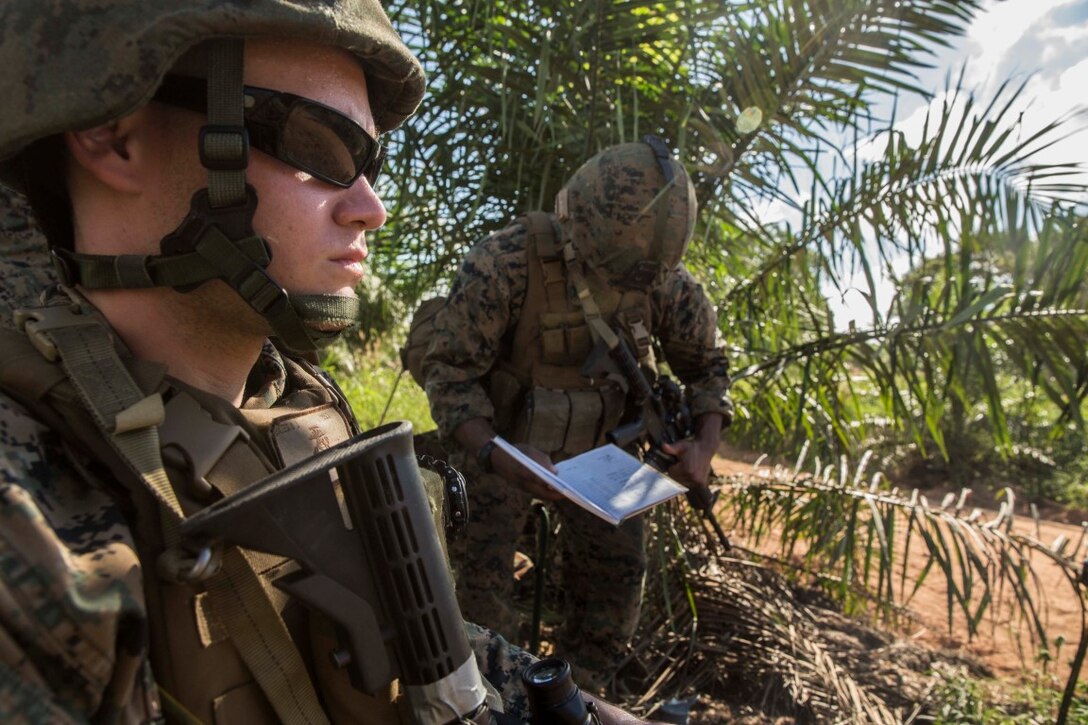 TANDUO BEACH, Malaysia (Nov. 12, 2015) U.S. Marine Cpl. Daniel Bates, left, and Cpl. Greg Tucker stand watch at a security check point during Malaysia-United States Amphibious Exercise 2015. Bates and Tucker are military policemen with Law Enforcement Detachment, Combat Logistics Battalion 15, 15th Marine Expeditionary Unit. During MALUS AMPHEX 15, Marines and Malaysian soldiers exchanged law enforcement tactics and learned how each other operate in a combat environment. The purpose of the exercise was to strengthen military cooperation in the planning and execution of amphibious operations between Malaysian armed forces and U.S. Marines. The 15th MEU is currently deployed in the Indo-Asia-Pacific region to promote regional stability and security in the U.S. 7th Fleet area of operations. (U.S. Marine Corps photo by Sgt. Emmanuel Ramos/Released)