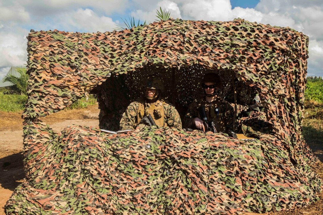 TANDUO BEACH, Malaysia (Nov. 12, 2015) U.S. Marine Cpl. Greg Tucker, left, and Cpl. Daniel Bates stand watch at a security check point during Malaysia-United States Amphibious Exercise 2015. Bates and Tucker are military police with Law Enforcement Detachment, Combat Logistics Battalion 15, 15th Marine Expeditionary Unit. During MALUS AMPHEX 15, Marines and Malaysian soldiers exchanged law enforcement tactics and learned how each other operate in a combat environment. The purpose of the exercise was to strengthen military cooperation in the planning and execution of amphibious operations between Malaysian armed forces and U.S. Marines. The 15th MEU is currently deployed in the Indo-Asia-Pacific region to promote regional stability and security in the U.S. 7th Fleet area of operations.  (U.S. Marine Corps photo by Sgt. Emmanuel Ramos/Released)