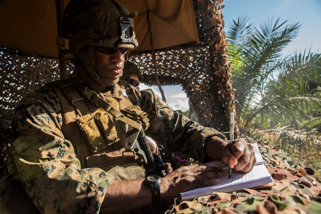 TANDUO BEACH, Malaysia (Nov. 12, 2015) U.S. Marine Cpl. Greg Tucker records incoming personnel at a security check point during Malaysia-United States Amphibious Exercise 2015. Tucker is a military policeman with Law Enforcement Detachment, Combat Logistics Battalion 15, 15th Marine Expeditionary Unit. During MALUS AMPHEX 15, Marines and Malaysian soldiers exchanged law enforcement tactics and learned how each other operate in a combat environment. The purpose of the exercise was to strengthen military cooperation in the planning and execution of amphibious operations between Malaysian armed forces and U.S. Marines. The 15th MEU is currently deployed in the Indo-Asia-Pacific region to promote regional stability and security in the U.S. 7th Fleet area of operations. (U.S. Marine Corps photo by Sgt. Emmanuel Ramos/Released)