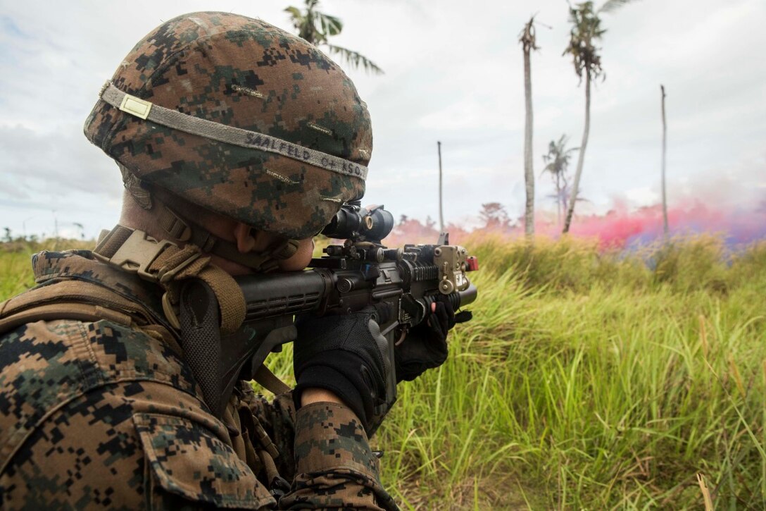 TANDUO BEACH, Malaysia (Nov. 13, 2015) U.S. Marine Cpl. Justin Saafield provides cover fire while conducting a beach assault with Malaysian soldiers during Malaysia-United States Amphibious Exercise 2015. Saafield is an assault team leader with Kilo Company, Battalion Landing Team 3rd Battalion, 1st Marine Regiment, 15th Marine Expeditionary Unit. During the culminating event, Malaysian soldiers alongside Marines assaulted the beach using tactics learned throughout MALUS AMPHEX 15. The purpose of the exercise was to strengthen military cooperation in the planning and execution of amphibious operations between Malaysian armed forces and U.S. Marines. The 15th MEU is currently deployed in the Indo-Asia-Pacific region to promote regional stability and security in the U.S. 7th Fleet area of operations. (U.S. Marine Corps photo by Sgt. Emmanuel Ramos/Released)