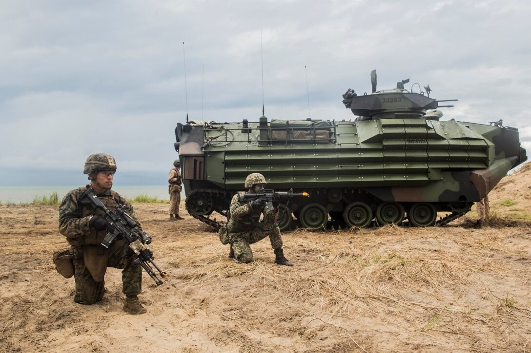 TANDUO BEACH, Malaysia (Nov. 13, 2015) U.S. Marine Lance Cpl. Jamie Camacho, left, and a Malaysian soldier begin their amphibious beach assault during Malaysia-United States Amphibious Exercise 2015. Camacho is an automatic rifleman with Kilo Company, Battalion Landing Team 3rd Battalion, 1st Marine Regiment, 15th Marine Expeditionary Unit. During the culminating event, Malaysian soldiers alongside Marines assaulted the beach using tactics learned throughout MALUS AMPHEX 15. The purpose of the exercise was to strengthen military cooperation in the planning and execution of amphibious operations between Malaysian armed forces and U.S. Marines. The 15th MEU is currently deployed in the Indo-Asia-Pacific region to promote regional stability and security in the U.S. 7th Fleet area of operations. (U.S. Marine Corps photo by Sgt. Emmanuel Ramos/Released)