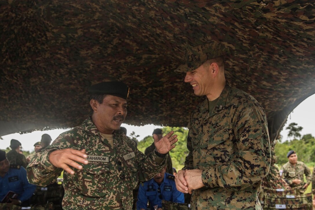 TANDUO, Malaysia (Nov. 13, 2015) U.S. Marine Col. Vance L. Cryer, right, speaks with Lt. Gen. Datuk Baharom bin Hamzah during the closing ceremony for Malaysia-United States Amphibious Exercise 2015. Cryer is the commanding officer of the 15th Marine Expeditionary Unit. Baharom is the commanding general of Joint Forces Command. The purpose of MALUS AMPEX 15was to strengthen military cooperation in the planning and execution of amphibious operations between Malaysian armed forces and U.S. Marines. The 15th MEU is currently deployed in the Indo-Asia-Pacific region to promote regional stability and security in the U.S. 7th Fleet area of operations. (U.S. Marine Corps photo by Sgt. Emmanuel Ramos/Released)