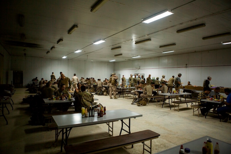 U.S. service members with Task Force Al Taqaddum sit down for a meal provided by the food service specialists at Al Taqaddum Air Base, Iraq, Nov. 7, 2015.  The food service members wake before the sun and toil into the late hours of the night to continue to provide support to U.S. and coalition forces in their day-to-day operations in support of Combined Joint Task Force-Operation Inherent Resolve. (U.S. Marine Corps photo by Sgt. Owen Kimbrel)