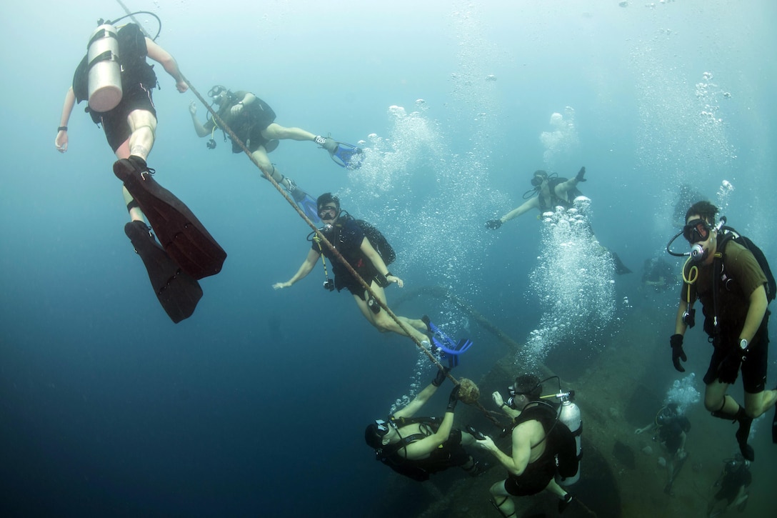 U.S. Navy explosive ordnance disposal technicians conduct diving operations with a South Korean underwater demolition team in waters off Santa Rita, Guam, Nov. 20, 2015. The U.S. sailors are assigned to Commander Task Force 75. U.S. Navy photo by Petty Officer 2nd Class Daniel Rolston