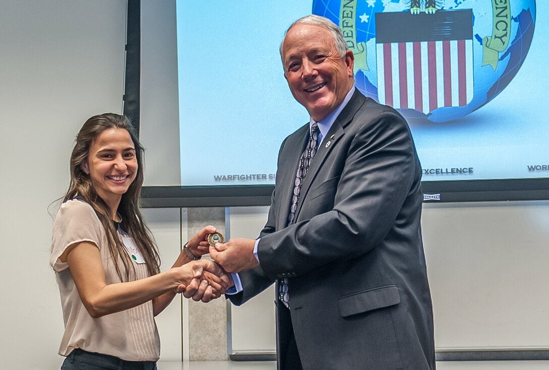 Monica M. Gaudier-Diaz, a third year graduate student in the Neuroscience Program at The Ohio State University, gave closing remarks at the mentoring program. James McClaugherty, DLA Land and Maritime deputy director, recognized the inspiring words and accomplishments of Gaudier-Diaz by presenting her an organization coin as a token of appreciation.  
