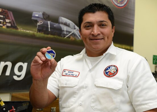 Eddie De La Paz, 47th Maintenance Directorate (MX) Component Maintenance Egress acting supervisor, shows the Knuckle Buster Coin at Laughlin Air Force Base, Texas, Nov. 20, 2015. De La Paz was presented with the first ever “Knuckle Buster Award” for his work in taking over the egress work center and instilling confidence in the 47th MX. (U.S. Air Force photo by Senior Airman Jimmie D. Pike)