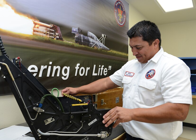 Eddie De La Paz, 47th Maintenance Directorate (MX) Component Maintenance Egress acting supervisor, inspects a T-6A Texan II ejection seat at Laughlin Air Force Base, Texas, Nov. 20, 2015. The egress workshop deals with equipment vital to the safety of Laughlin students and pilots. (U.S. Air Force photo by Senior Airman Jimmie D. Pike)