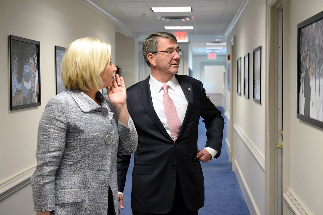 U.S Defense Secretary Ash Carter shows Dutch Defense Minister Jeanine Hennis-Plasschaert photos from some of his previous trips this year while walking in the Pentagon, Nov. 23, 2015. DoD photo by Army Sgt. 1st Class Clydell Kinchen