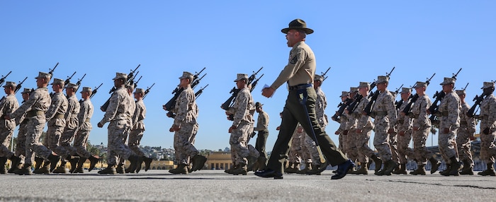 A drill instructor of Mike Company, 3rd Recruit Training Battalion, marches his recruits during Final Drill at Marine Corps Recruit Depot San Diego, Nov. 23. Final Drill is one of the last tests the recruits face before earning the title Marine. Today, all male recruits recruited from recruiting stations west of the Mississippi are trained at MCRD San Diego. The depot is responsible for training more than 16,000 recruits annually. Mike Company graduates recruit training Dec. 11.